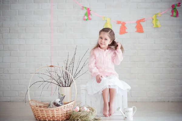 Little girl with rabbit and easter decorations — Stock Photo, Image