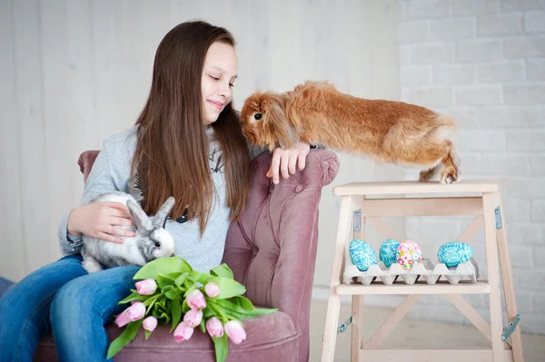 Girl with Easter eggs and two rabbits — Stock Photo, Image