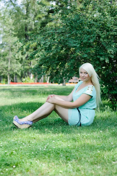 Blondin poserar på gräset — Stockfoto