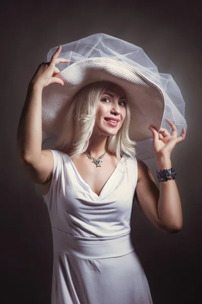 Blonde girl in white dress and hat — Stock Photo, Image