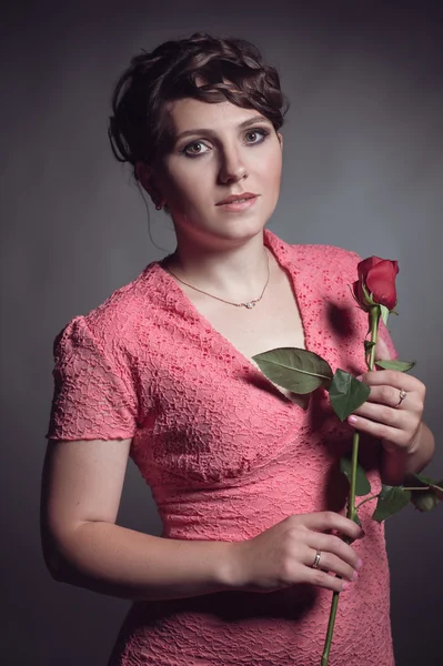 Brunette woman in pink dress — Stock Photo, Image