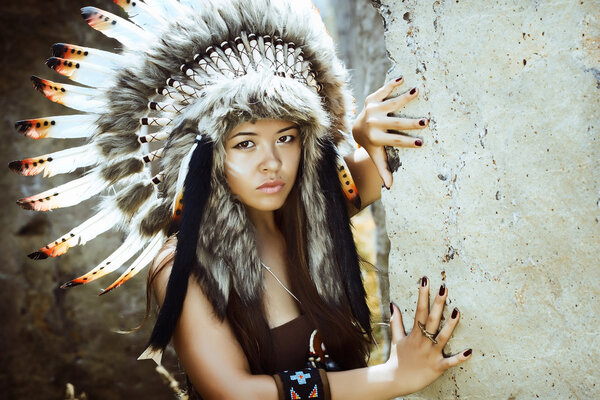 Native american, Indians in traditional dress, standing  to the stone slabs.