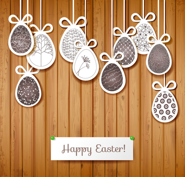 Easter card with eggs on wooden background.