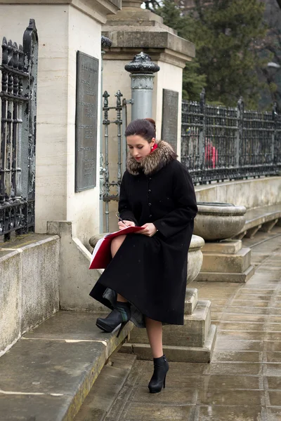 The girl makes historical entry in the folder — Stock Photo, Image