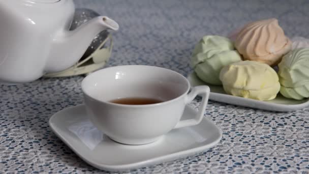 Girl Takes Kettle Pours Hot Tea Cup Puts Kettle Table — Stock Video