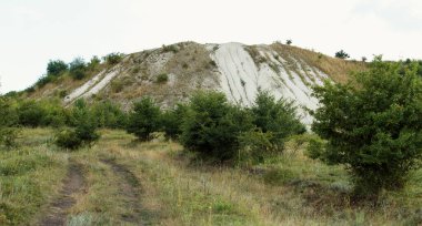 Old abandoned plaster pit located in a forest belt in which extracted plaster earlier