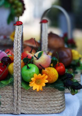 Basket with artificial different fruits, bright color, beautiful decoration in kitchen interior