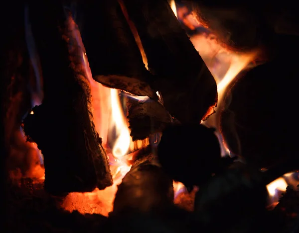 Fire of high temperature from firewood burns in fireplace, romantic