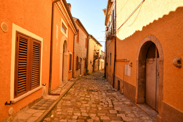 A small street between the old houses of Pignola, a small town in the province of Potenza in Basilicata, Italy.