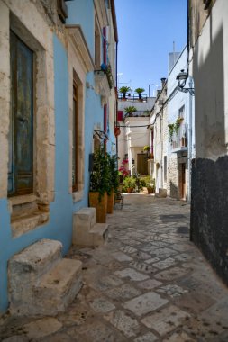 A narrow street between the old houses of Casamassima, an Apulian village in the province of Bari, Italy.