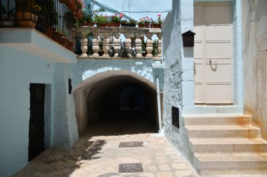 A narrow street between the old houses of Casamassima, an Apulian village in the province of Bari, Italy.