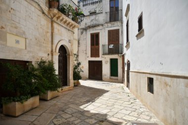 A narrow street between the old houses of Casamassima, an Apulian village in the province of Bari, Italy.