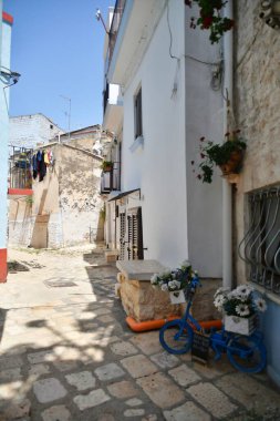 A narrow street between the old houses of Casamassima, an Apulian village in the province of Bari, Italy.