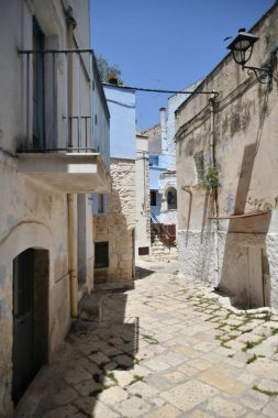A narrow street between the old houses of Casamassima, an Apulian village in the province of Bari, Italy.