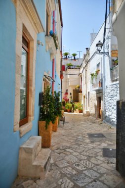 A narrow street between the old houses of Casamassima, an Apulian village in the province of Bari, Italy.