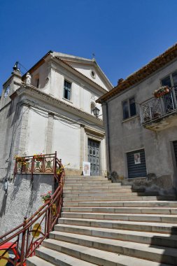 A narrow street between the old houses of Marsicovetere, a village in the mountains of Basilicata, Italy.