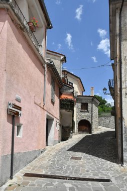 A narrow street between the old houses of Sasso di Castalda, a village in the mountains of Basilicata, Italy.