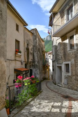 A narrow street between the old houses of Petina, a village in the mountains of Salerno province, Italy.