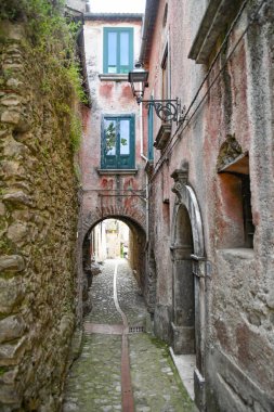 A narrow street between the old houses of Petina, a village in the mountains of Salerno province, Italy.