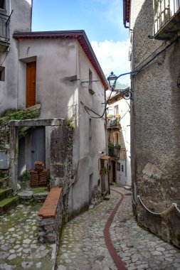 A narrow street between the old houses of Petina, a village in the mountains of Salerno province, Italy.