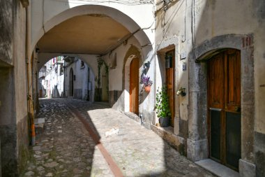 A narrow street between the old houses of Petina, a village in the mountains of Salerno province, Italy.