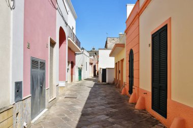 A narrow street between the old houses of Presicce, a picturesque village in the province of Lecce in Italy.