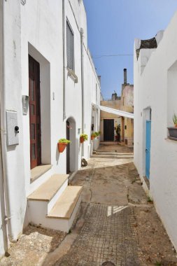 A narrow street between the old houses of Presicce, an Apulian village in the province of Lecce, Italy.