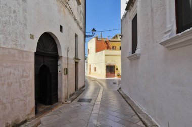 A narrow street between the old houses of Presicce, an Apulian village in the province of Lecce, Italy.
