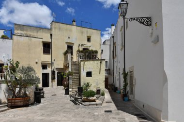 A narrow street between the old houses of Galatina, an Apulian village in the province of Lecce, Italy.