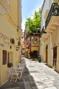 A narrow street between the old houses of Gallipoli, an Apulian village in the province of Lecce, Italy.
