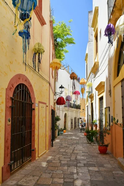 A narrow street between the old houses of Gallipoli, an Apulian village in the province of Lecce, Italy.