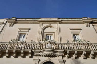 The balcony of an old Baroque style house in Maglie, a village in the Puglia region of Italy.