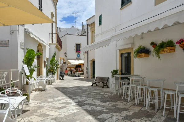 A narrow street among the old houses in the historic center of Otranto, a town in Puglia in Italy.