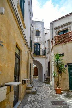A narrow street among the old houses in the historic center of Otranto, a town in Puglia in Italy.