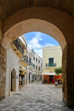 A narrow street among the old houses in the historic center of Otranto, a town in Puglia in Italy.