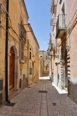 A narrow street among the old houses of Irsina in Basilicata, region in southern Italy.