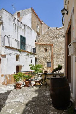 A narrow street among the old houses of Irsina in Basilicata, region in southern Italy.
