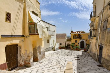 A narrow street among the old houses of Irsina in Basilicata, region of southern Italy.