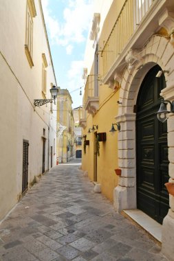 A narrow street between the old houses of Uggiano, a medieval town in the Puglia region of Italy.