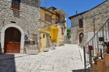 A narrow street between the old houses of Pietrelcina a village in the province of Benevento, Italy.