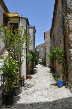 A narrow street between the old houses of Pietragalla, a village in the Basilicata region, Italy.