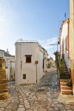 A narrow street between the old houses of Grottole, a village in the Basilicata region, Italy.