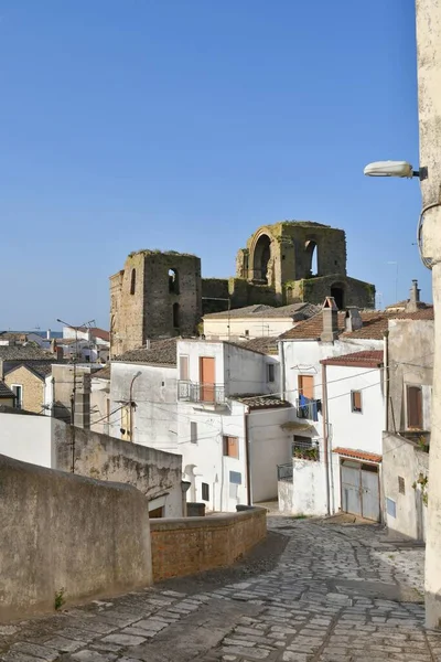 A narrow street between the old houses of Grottole, a village in the Basilicata region, Italy.