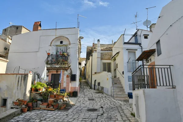A narrow street between the old houses of Grottole, a village in the Basilicata region, Italy.