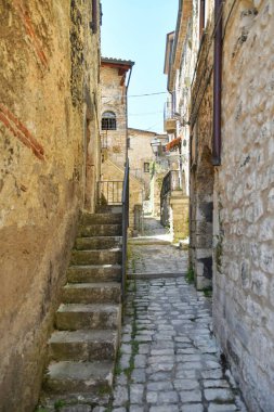 A narrow street between the old stone houses of Campo di Giove, a medieval village in the Abruzzo region of Italy.