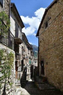 A narrow street between the old stone houses of Campo di Giove, a medieval village in the Abruzzo region of Italy.