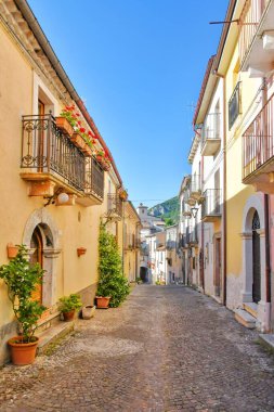 A narrow street between the old stone houses of Cansano, a medieval village in the Abruzzo region of Italy.