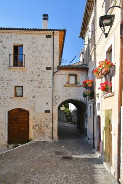 A narrow street between the old stone houses of Cansano, a medieval village in the Abruzzo region of Italy.