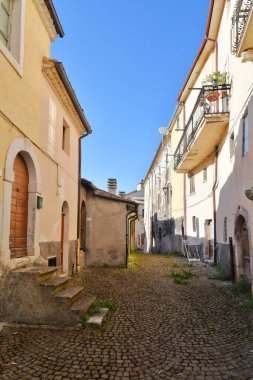 A narrow street between the old stone houses of Cansano, a medieval village in the Abruzzo region of Italy.