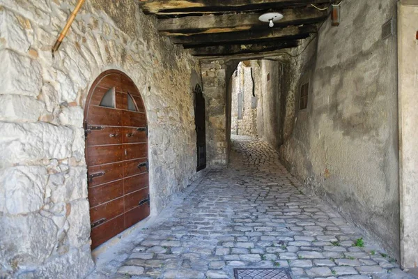 A narrow street between the old stone houses of Campo di Giove, a medieval village in the Abruzzo region of Italy.